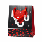 Cadeautasje met I Love You tekst en rood glitterhart op witte achtergrond